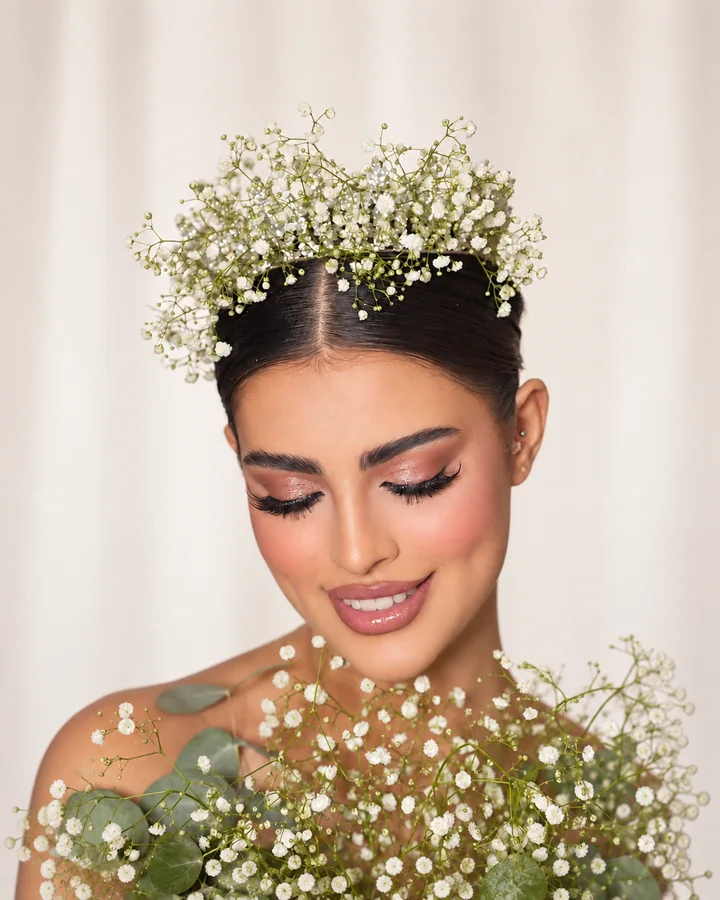 Soft bridal makeup framed by delicate white flowers