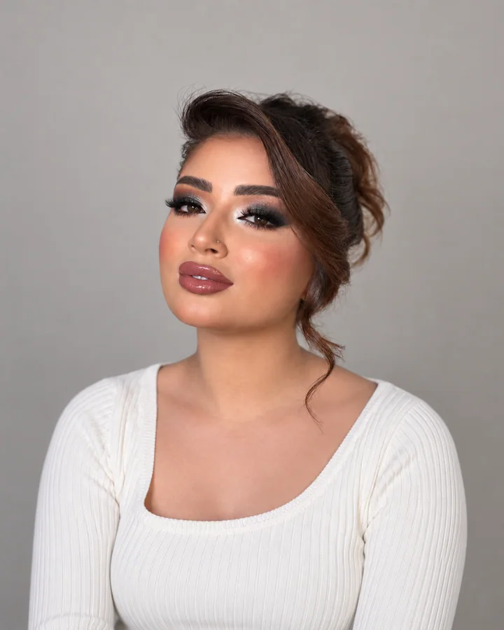 Smoky occasion makeup with a softly styled brown updo