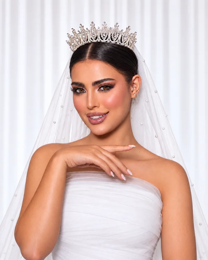 Bridal makeup with a tiara and pearl-edged veil