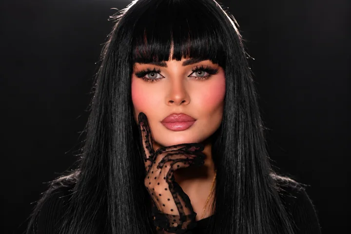 Pink evening makeup with black fringe and a lace glove